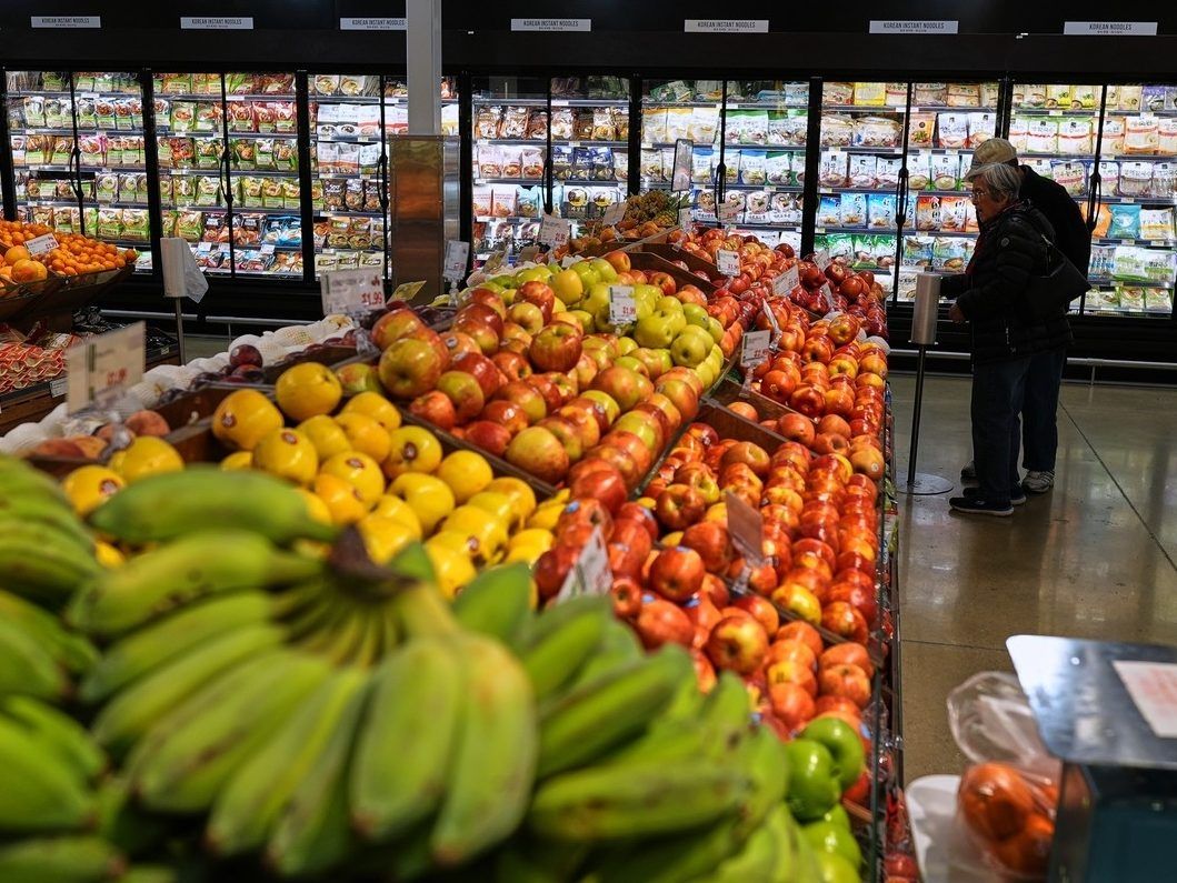 People shop at a grocery store, in Schaumburg, Ill., Thursday, April 2, 2026.