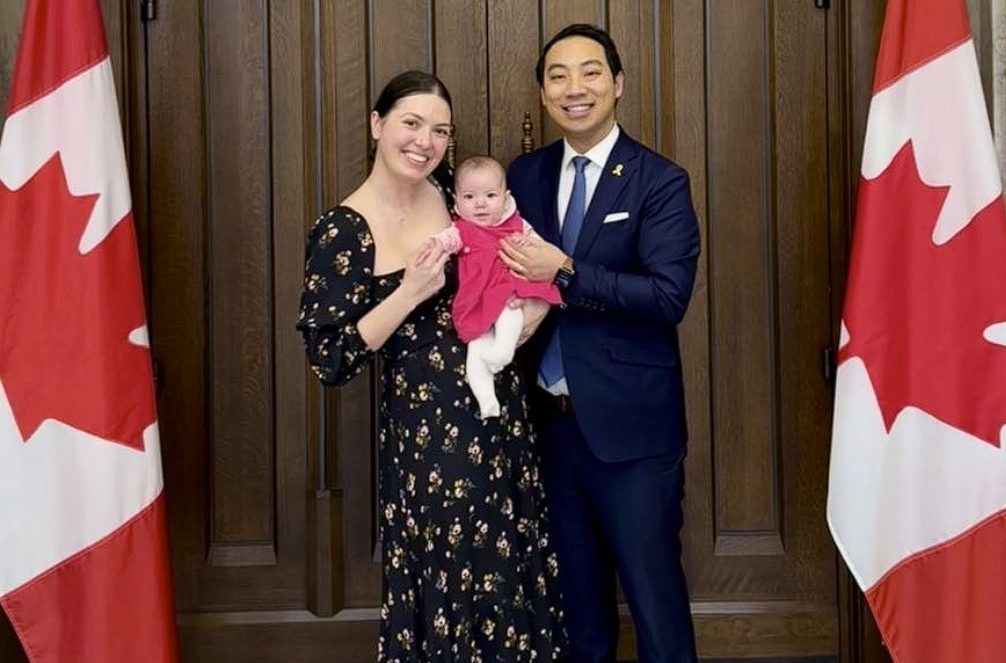 Former MP Kevin Vuong stands in the foyer of the House of Commons with wife Elizabeth and daughter Victoria