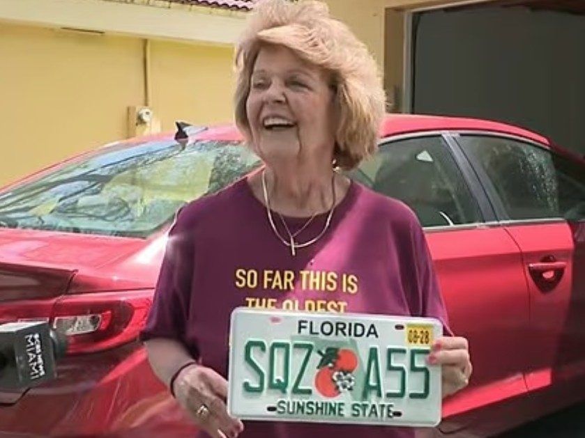 Nancy Dello Stritto, 76, holding up her wild new licence plate.