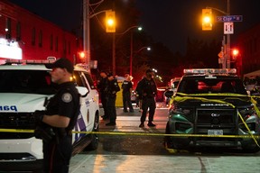 Police officers and other law enforcement personnel are seen at the intersection of St. Clair W. and Arlington Ave., near the site of a shooting that occurred at the Salsa on St. Clair Festival in Toronto on the evening of July 11, 2026.