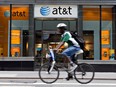 A cyclist passes an AT&T store in New York