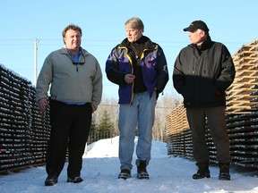 Osisko executives Sean Rosen (left),  John Burzynski and Robert Wares walk by stacks of core samples at the Malartic mine