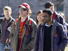 Students walk through a park at Queen's University in Kingston, Ontario.