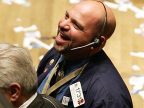 A happy trader on the floor of the New York Stock Exchange.
