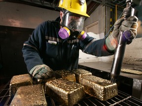 An air-powered tool is used to clean bars of gold at the Red Lake Goldcorp mine.