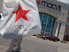 A shopper carries a bag from the Macy's store at Polaris Fashion Place, a shopping mall in Columbus, Ohio.