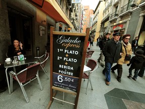 A sign outside a restaurant offers a 6.50 euro lunch menu in Madrid, Spain. The private sector has suffered in much of Europe due to rising unemployment.