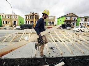 A construction worker works on building new homes in Calgary, Alberta.