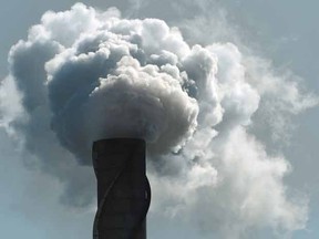 Smoke and steam billows from an exhaust stack