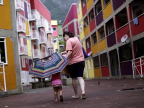 A woman walks with her child in Rocinha slum in Rio de Janeiro, Brazil. Victoria Ransom has lived in a favela in Brazil.