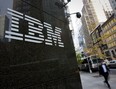 Pedestrians walk past International Business Machines Corp. (IBM) offices in New York