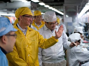 Apple chief executive Tim Cook visiting the iPhone production line at the Foxconn manufacturing facility at Zhengzhou Technology Park in China's north-central Henan province.