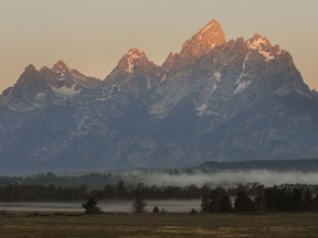 Early morning sunlight illuminates the top of the Teton mountain range in Jackson Hole, Wyoming. At each year’s Jackson Hole conference, the Fed chairman is a focal point.
