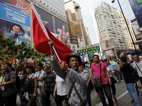 A protester dressed as a soldier chants slogans outside a Japanese department store during a protest march, against Japan's decision to buy the disputed island which Japan calls Senkaku and China calls Diaoyu islands, in Hong Kong September 16, 2012. China is a frequent destination for Canadian business travellers, but social and political rest in the emerging market comes with risks.