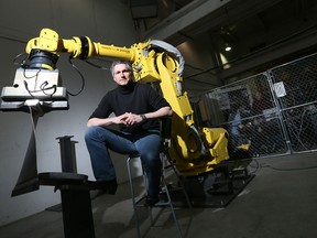 Eric Beauregard, CEO of AV&R Vision & Robotics poses with one of their robotics used in servicing the aerospace industry. The business leader says the global economic downturn gave him the push to explore European markets, a move that led to greater geographic diversification down the road.