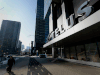 A pedestrian passes in front of the Telus Corp. building in Toronto.