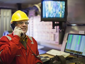 Worker talking on phone in control room