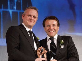 Steve Meurice, left, editor-in-chief of National Post, presents the Special Citation for Financial Performance to Robert Herjavec during the 2012 National Ernst & Young Entrepreneur Of The Year Awards at the Fairmont Royal York Hotel in Toronto.