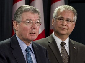 Minister of State (Science and Technology) Gary Goodyear listens to the President of the National Research Council of Canada John McDougall (left) respond to a question during a news conference Tuesday May 7, 2013 in Ottawa.
