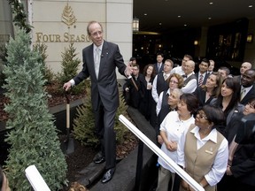 Four Seasons founder Isadore Sharp (left) joins hotel employees in a tree planting ceremony in the Lobby Lounge conservatory at the Four Seasons on Avenue Road in Toronto. Mr. Sharp has made it a policy to have all new hires meet wit with the hotel's general manager to ensure they fit the company culture.