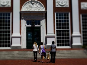 Students enter a building at Harvard University's Business School in Cambridge, Massachusetts, U.S.