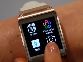 A model touches the screen of a Samsung Galaxy Gear smartwatch in Berlin, Germany.