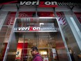 A pedestrian walks past a Verizon Wireless store in New York