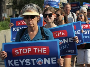 Activists march to the U.S. State Department to protest against the Keystone XL pipeline August 12, 2013 in Washington, D.C.