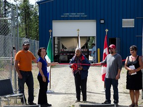 Chief Liard McMillan, Yukon’s Regional Director General for Aboriginal Affairs and Northern Development Canada, Shari Borgford, elder Mida Donnessey, facility operator Johnathon Stockman, and Cindy Porter, a representative of Liard First Nation, cut the ribbon and officially open the Liard First Nation Water Treatment Plant in Watson Lake, Yukon, August 2, 2013.