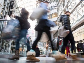 Shoppers carry their purchases through Toronto's Eaton Centre