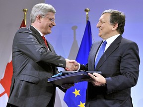European Commission President Jose Manuel Barroso (R) shakes hand with Canadian Prime Minister Stephen Harper (L) during a signing ceremony of a free-trade accord more than four years in the making, on October 18, 2013 at the EU headquarters in Brussels.
