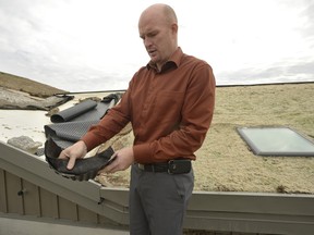 Tyler Whale, University of Guelph Industry Liaison Officer, discusses the base and  membrane that the test sloped green roof uses.