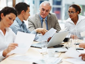 Multi ethnic business executives at a meeting discussing a work