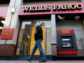 A man walks past a Wells Fargo location in Philadelphia