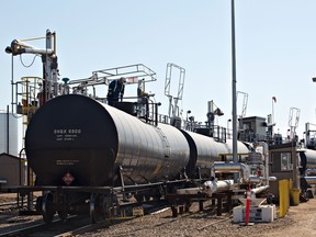 A worker fills a rail car with oil at Canexus in Bruderheim, Alberta