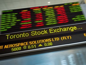 Financial numbers are seen on the digital ticker tape at the TMX Group in Toronto, Ont.
