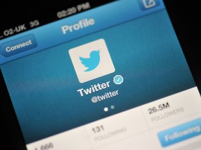 The Twitter logo is displayed on a mobile device.