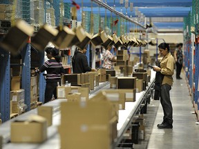 Workers receive boxes through the automated box delivery system, pick ecommerce orders, place them in boxes, and send complete orders through the conveyor to the automated shipping system.