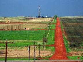 Oil rigs and freshly bladed-off roads dot the landscape near the Fort Berthold Reservation in New Town, N.D.
