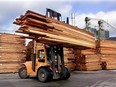 A lift truck piles cedar planks from Interfor's Hammond Cedar Division mill in Maple Ridge, B.C.