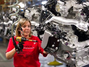 In this file photo, engine specialist Jennifer Souch assembles a Camaro engine at the GM plant in Oshawa, Ont.