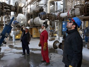 Iranian oil workers at Tehran's oil refinery, near the capital. Iran sits on the world's fourth-largest crude oil and second-largest natural gas reserves.