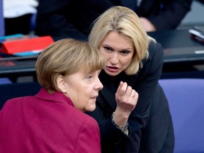Manuela Schwesig (R), German Minister of Family Affairs, Senior Citizens, Women and Youth, speaks with German Chancellor Angela Merkel during a session at the Bundestag (lower house of parliament) on March 5, 2015 in Berlin. Deputies at the Bundestag (lower house of parliament) voted on March 5, 2015 for the introduction of compulsory quota for women in the supervisory boards of 108 companies from the year 2016.       AFP PHOTO / DPA / SOEREN STACHE    +++    GERMANY OUTSOEREN STACHE/AFP/Getty Images