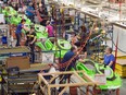 Employees work on the SeaDoo assembly line at the Bombardier Recreational Products plant in Valcourt, Que.