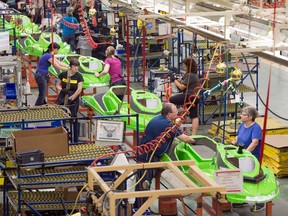 Employees work on the SeaDoo assembly line at the Bombardier Recreational Products plant in Valcourt, Que.