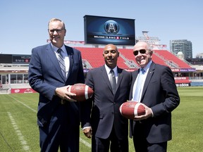 George Cope, (left to right) CEO of Bell Canada, Jeffrey Orridge, CFL commissioner, and Larry Tanenbaum, MLSE chairman, pose at BMO Field following a press conference in Toronto on Wednesday, May 20, 2015.