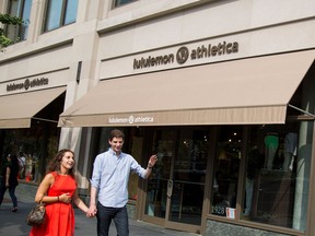 Pedestrians walk past a Lululemon Athletica Inc. store in New York.