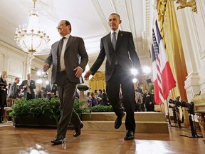 French President Francois Hollande (L) and U.S. President Barack Obama leave the East Room following a joint news conference at the White House November 24, 2015 in Washington, DC.
