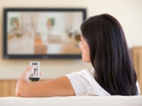 Woman in living room watching television