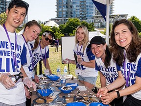 Telus employees volunteer for local charities as part of their “Day of Giving” initiative